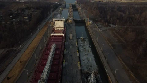 Flight over two cargo ships at the top of a major lock system Stock Footage 229052777