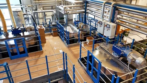 A flight over the upper tier of the plant, where steel tanks with motors Stock Footage 311998340