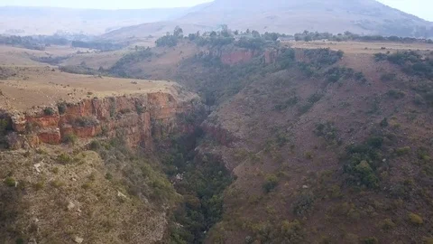 Flight over valley with small river in the middle Vídeo Stock 78584495