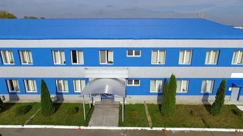 Flight over warehouse storage blue building facade exterior HD aerial video Stock Footage 72219269
