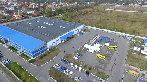 Flight over warehouse storage building exterior HD aerial video. Industrial area Stock Footage 72219136