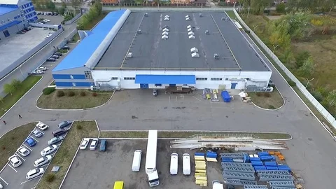 Flight over warehouse storage building exterior HD aerial video. Industrial area Stock Footage 72219174