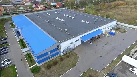 Flight over warehouse storage building exterior HD aerial panorama video Stock Footage 72219195