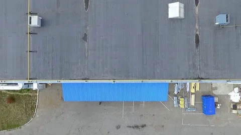 Flight over warehouse storage building exterior HD aerial video. Industrial area Stock Footage 72219220