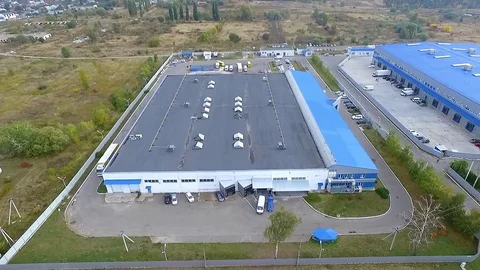 Flight over warehouse storage buildings HD aerial video. Industrial area village Stock Footage 72219257