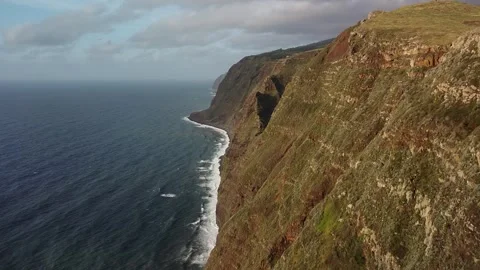 Flight over Waves Meet Rugged Coast Madeira Stock Footage 254421896