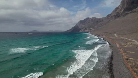 Flight over waves splash on desert beach Video stock 244216042