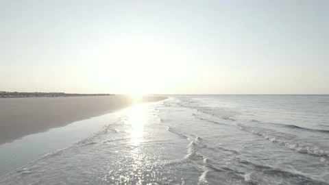 Flight over waves as sun rises 5.4k 24fps D-Log footage Stock Footage 209618310