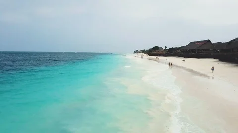 Flight over wide paradise beach with white sand and azure ocean on cloudy day 動画素材 91801167