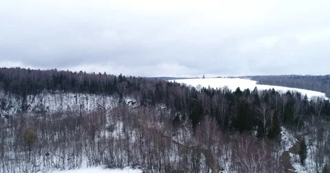 Flight over the winter forest and a ravine Stock Footage 73690528