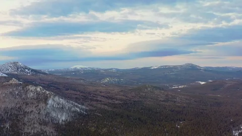 Flight over the winter forest and snow-capped mountains Stock Footage 125524444