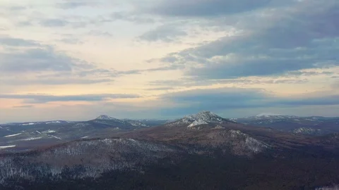 Flight over the winter forest and snow-capped mountains Stock Footage 125550645
