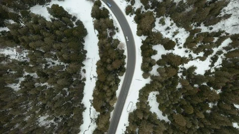 Flight over the winter mountains with road serpentine Stock Footage 125056593