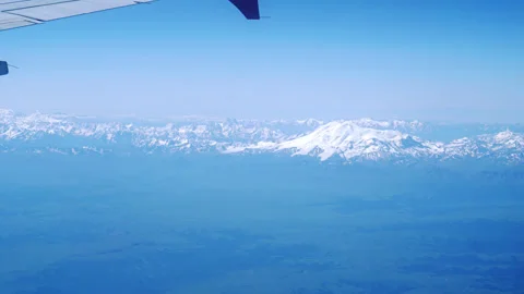 The flight of a passenger plane over the mountains. Video stock 246877724