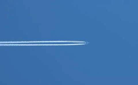 Flight of a passenger plane in the sky. Stock Photos
