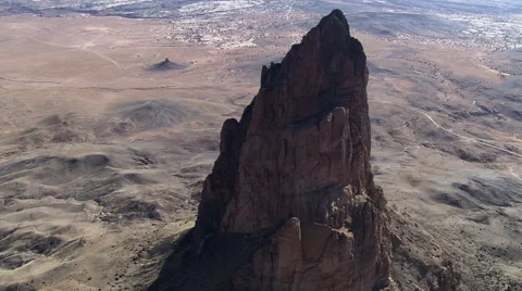Flight passing Agathla Peak (El Capitan) in Monument Valley Stock Footage