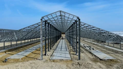 Flight past the construction of a large metal structure in agricultural area Stock Footage 306300577