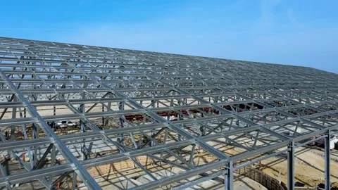 Flight past the construction of a large metal structure in agricultural area Stock Footage 306300594