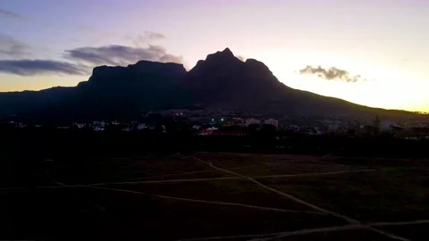 Flight past Table Mountain during colourful sunset Stock Footage 233428404