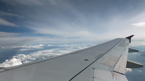 Flight of the plane on a flight level, against the background of blue sky and Stock Footage 103515758