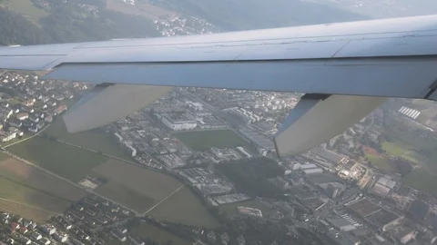 Flight by plane over the city. View from the window of the airplane. Ultra HD Stock Footage 121437181