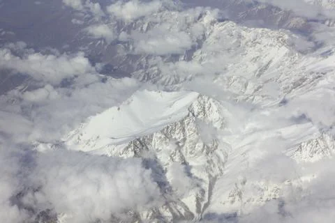 Flight on the plane over the mountains Stock Photos