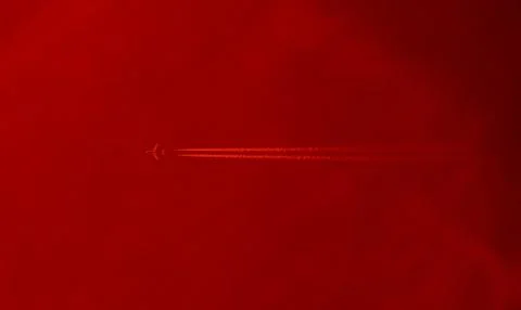 Flight of the plane at sunset. Stock Photos