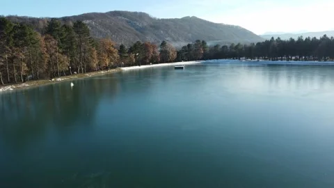 Flight on a quadcopter over a lake covered with ice in the distance Stock Footage 167580782