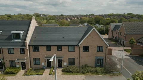 Flight right to left over a new housing development beige and dark grey slate Stock Footage 296821678
