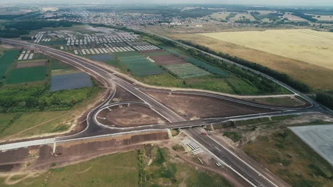 Flight to the road junction under construction outside the city. Road under Stock-Footage 137957228