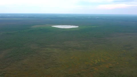Flight to the round lake over the endless forest Video stock 135792021