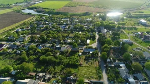 Flight to the Russian village with agricultural fields, gardens and lakes. Under Stock Footage 125337953