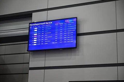 Flight schedule and check-in counter in airport Stock Photos