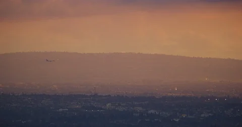 Flight seen in beautiful light during sunset in Los Angeles, California Stock Footage 115079384