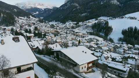 Flight shot over rooftops of ski center Val Gardena in Italy, Dolomites, Alpes Stock Footage 121261075
