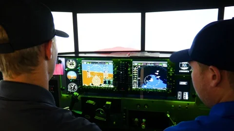 Flight simulation instructor teaches the pilot student to ride a plane Stock Footage 115894500