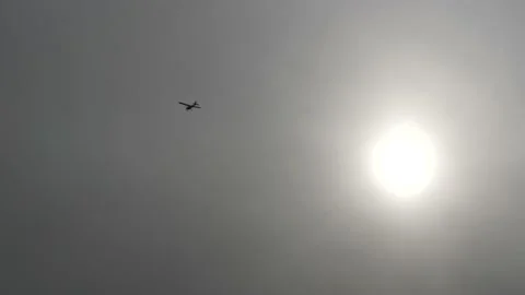 Flight of a single-engine private plane on a background of overcast sun. Video stock 146827432