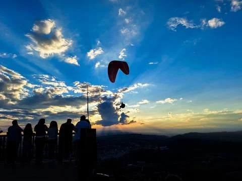 A flight in the sky, a crowd on the ground. Stock Photos