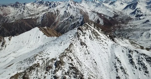 Flight to snow peak. Rocks covered with snow. Video stock 95988438