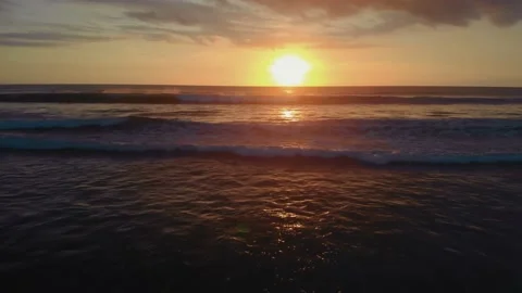 Flight at sunset overlooking the Indian Ocean in Bali Indonesia. Stock Footage 145894868