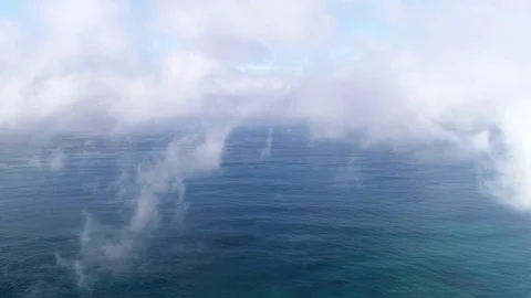 Flight through the clouds in the sky, over the Ocean Stock Footage