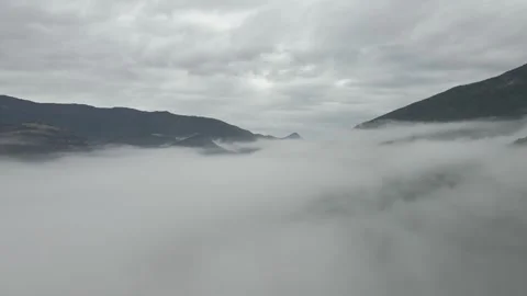 Flight through the clouds towards the high snow-capped mountains Stock Footage 260882826