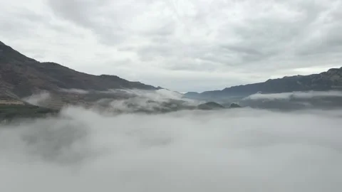 Flight through the clouds towards the high snow-capped mountains Stock Footage 294263236