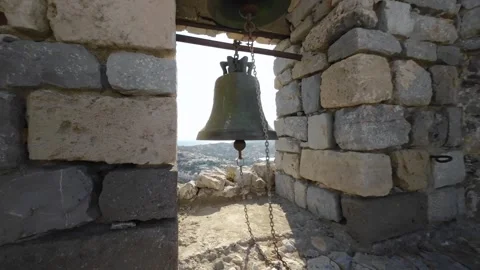 Flight through a fortress wall window past a church bell Stock Footage 245311164