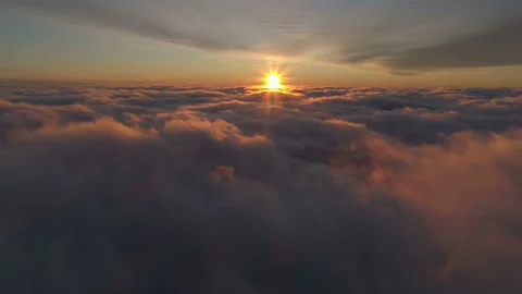 Flight through moving cloudscape with beautiful sun rays. Sunset in the sky. Stock Footage 125615840