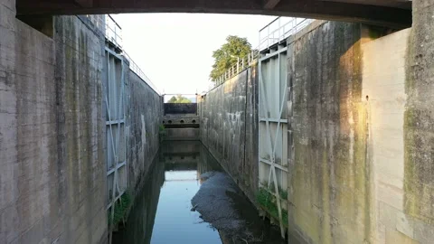 Flight through opened lock chamber of small hydroelectric powerplant. Stock Footage 137438281