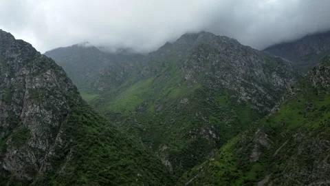 Flight through rainy, cloud covered mountains Stock Footage 197212018