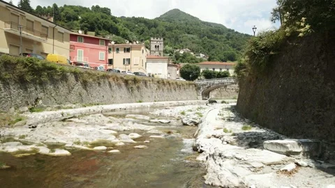 Flight through a river bed in a village Stock Footage 159061593