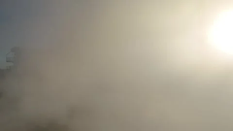 Flight through smoke opening onto factory structures Stock Footage 331203502