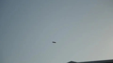 Flight of a throwing disc against the background of the sky.  in slow motion Stock Footage 320393378